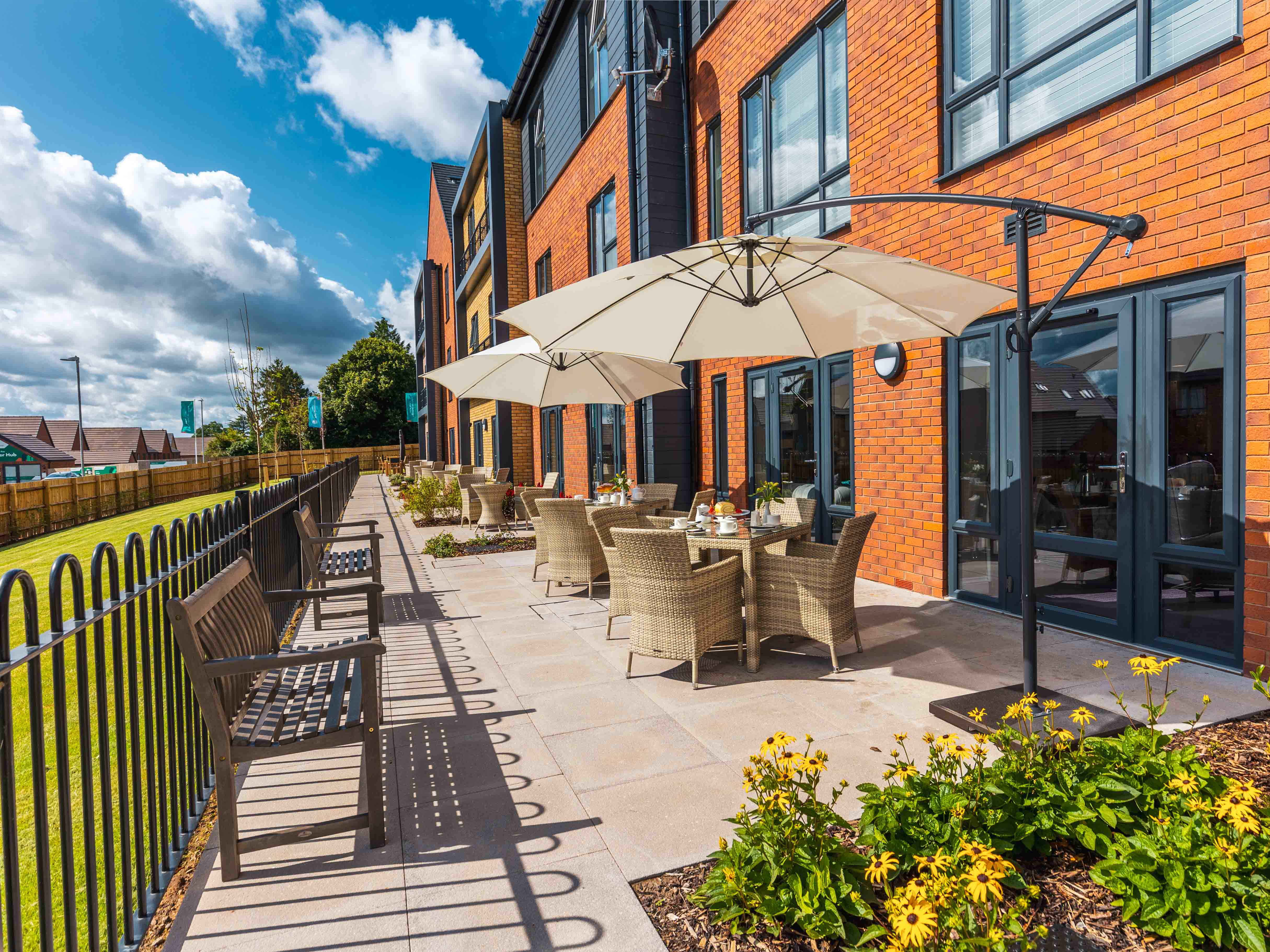 Alexander Rose outdoor tables and chairs on the terrace of a senior living complex
