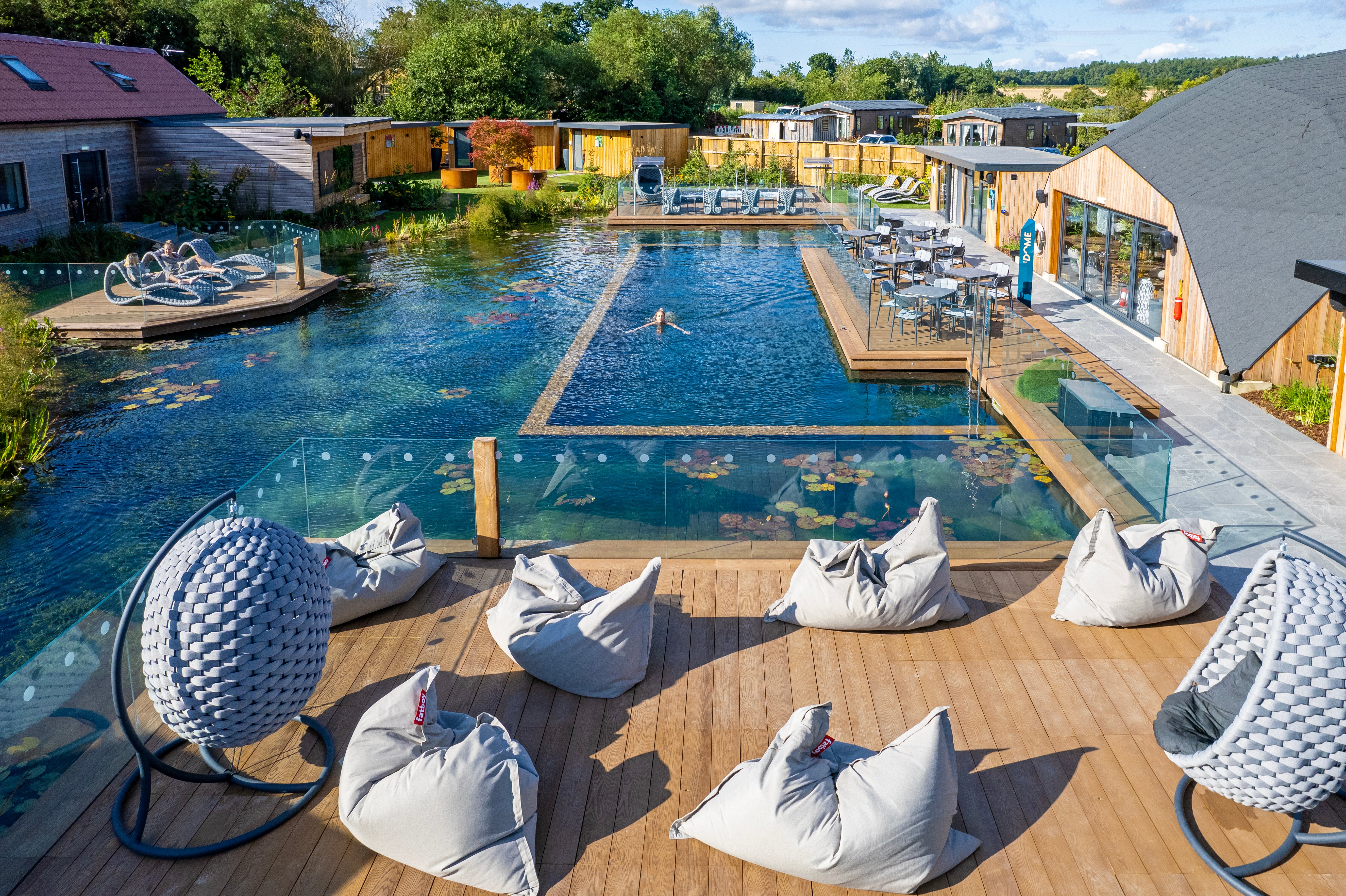 Alexander Rose Cordial Luxe Hanging outdoor chairs at Yorkshire Spa overlooking a pool