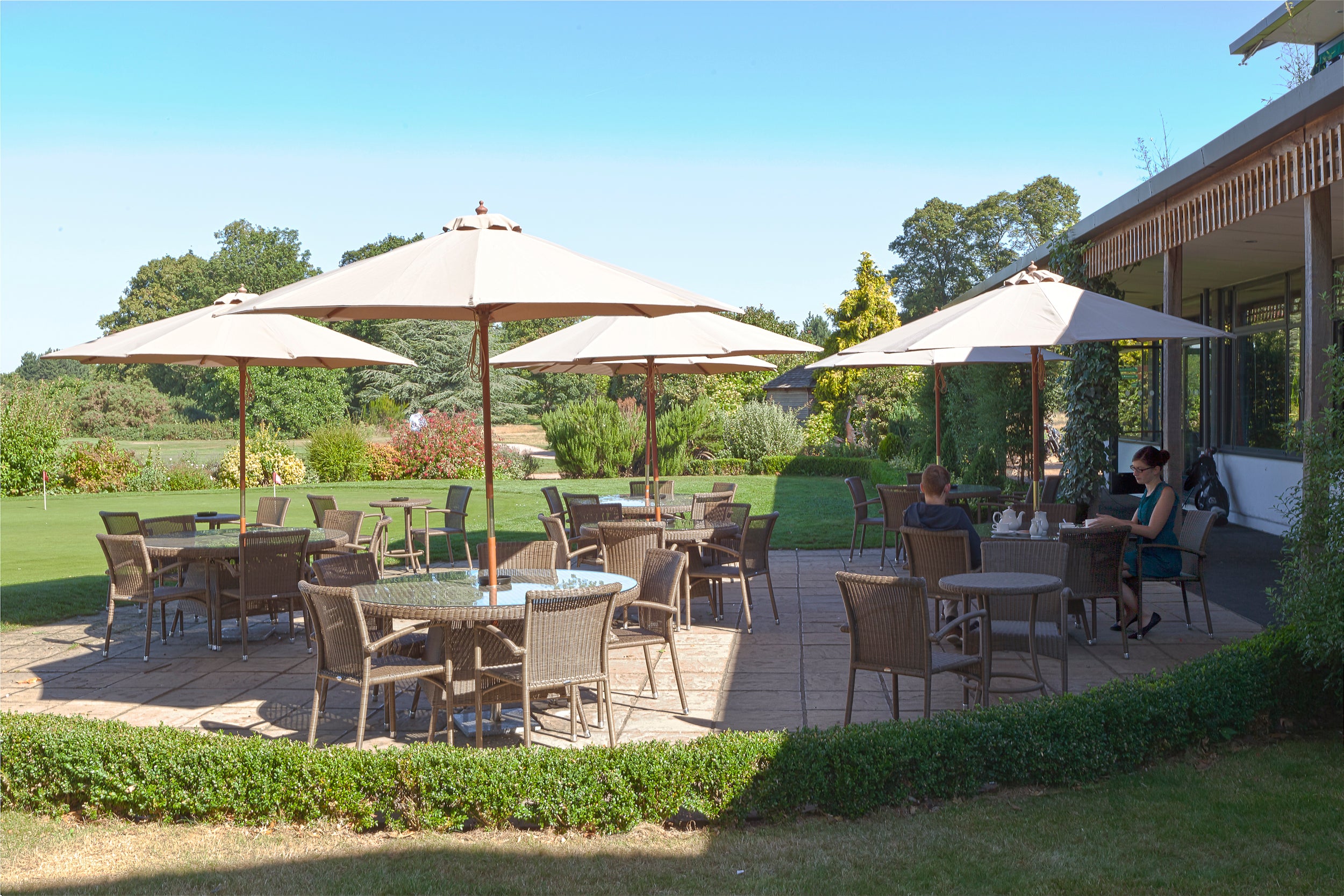 Alexander Rose Commercial tables and chairs and parasols outside of mid sussex golf club