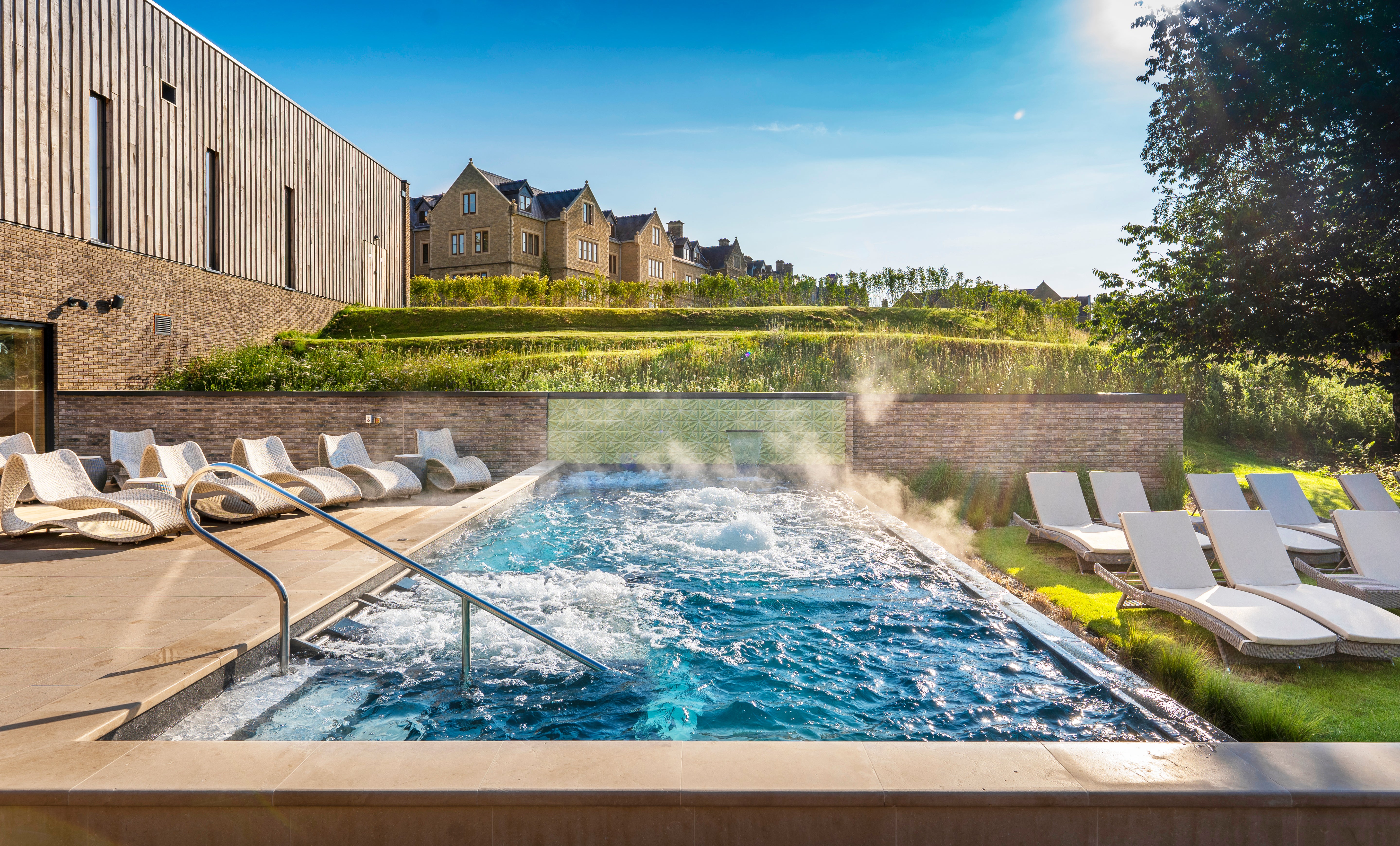 Alexander Rose Hazelmere collection of sunbeds and sun loungers in a luxury weave surrounding the bubbling outdoor spa at South Lodge