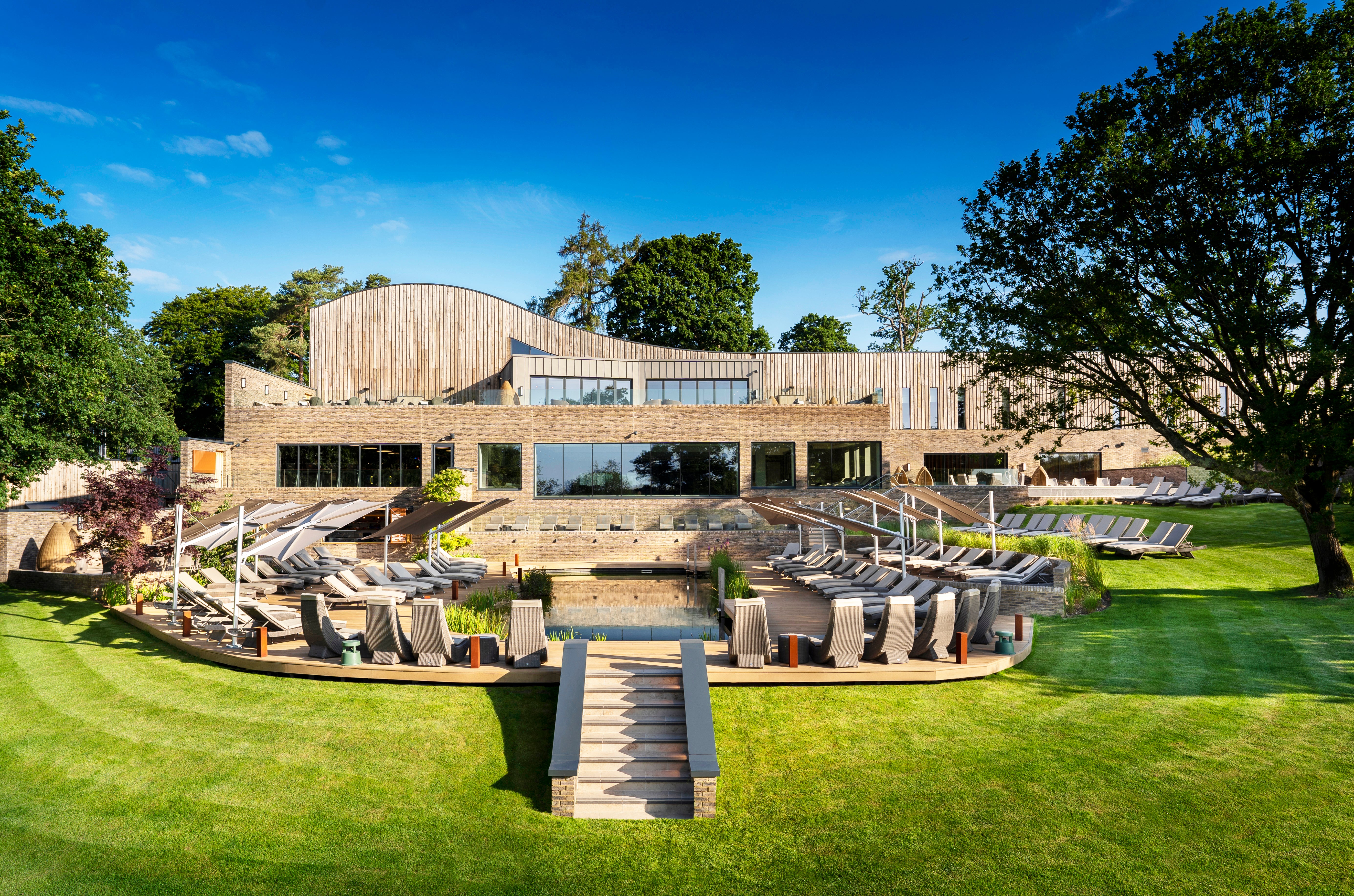 The exterior of South Lodge Spa with the Alexander Rose luxury furniture across the spa area and lawns
